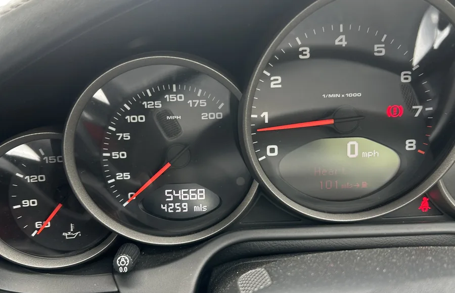 Porsche instrument cluster showing recorded mileage